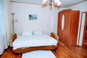 a bedroom with a bed and a dresser in it at Līvijas apartamenti in Kuldīga