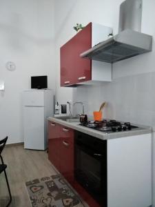 - une cuisine équipée d'un four avec plaques de cuisson en noir et blanc dans l'établissement Luna Casmene, à Comiso