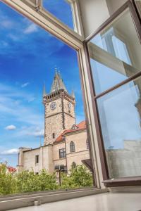 a window view of a building with a clock tower at Old Town Square Apartment in Prague