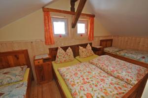 StallにあるLärchenhütteのベッドルーム1室(ベッド2台、窓2つ付)