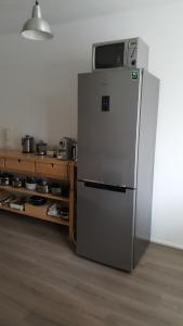 Un refrigerador con un microondas encima en una cocina. en Quiet spacious room, en Ámsterdam