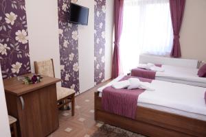 Voodi või voodid majutusasutuse Garni Hotel Laguna Lux toas