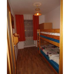 a bedroom with two bunk beds and a window at All inkl Card Fewo1-Heigl in Viechtach