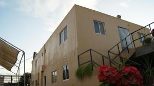 a building with a staircase on the side of it at Suites Hgen in Los Mochis