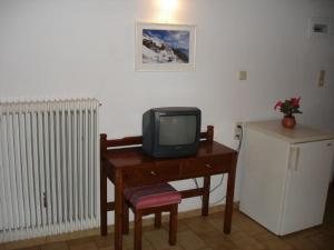a small television sitting on a desk with a chair at Elena Beach in Chania