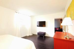 a bedroom with a bed and a red dresser and a chair at On The Beach - Lux 2 Bedroom Miami in Hollywood +17 photos