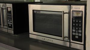 two microwaves sitting on top of a microwave at Paso Severino Centro de recreación in Mendoza