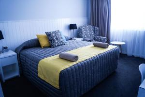 1 dormitorio con 1 cama con 2 almohadas en Oasis Motel, en Cobar