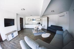 a living room with a couch and a table at Villa Tower Nad Jeziorem Nyskim in Skorochow