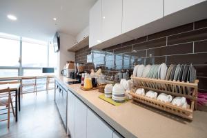 a kitchen with a counter with dishes on it at K-Guesthouse Premium Nampo 1 in Busan