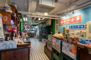 a grocery store with signs on the wall at YHA Mei Ho House Youth Hostel in Hong Kong