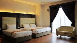 מיטה או מיטות בחדר ב-Hotel Grand Baron