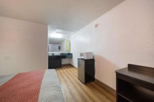 a small room with a bed and a kitchen at Motel 6-Hamburg, NY in Hamburg