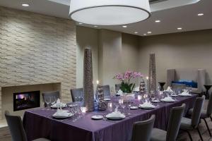 a conference room with a long table with chairs and a fireplace at Hyatt Regency Deerfield in Deerfield