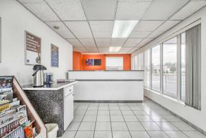 a kitchen with orange and white walls and a counter at Motel 6-Windsor, ON in Windsor