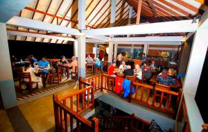 a group of people sitting at tables in a restaurant at Elephas Resort & Spa in Sigiriya
