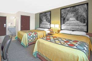 a hotel room with two beds in a room at Super 8 by Wyndham Windsor/Madison North in Windsor
