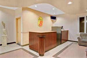 a lobby with a bar in a fast food restaurant at Super 8 by Wyndham Milford/New Haven in Milford