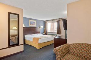 A bed or beds in a room at Super 8 by Wyndham Milford/New Haven