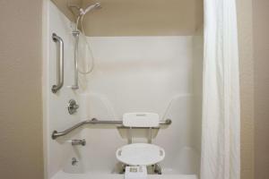 a small bathroom with a toilet and a shower at Super 8 by Wyndham Fort Chiswell Wytheville Area in Max Meadows +45 photos