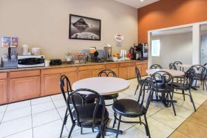 a restaurant with tables and chairs and a counter at Super 8 by Wyndham Corvallis in Corvallis