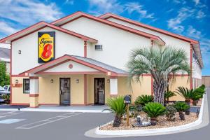 a fast food restaurant with a building at Super 8 by Wyndham Douglas in Douglas