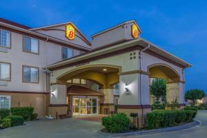 a hotel with a sign on the front of it at Super 8 by Wyndham Hillsboro TX in Hillsboro