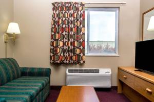 a living room with a couch and a window at Super 8 by Wyndham Beresford in Beresford