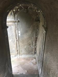 an archway in a stone wall with a door at Villa Eugenia in Livorno