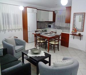 a kitchen and living room with a table and chairs at Green view village in Pitrofós