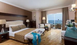 A bed or beds in a room at Mukarnas Spa & Resort Hotel