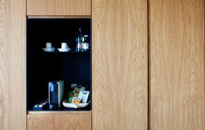 a cupboard with a phone and a bowl of food at Hotel Arima & Spa - Small Luxury Hotels in Donostia-San Sebastián