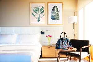 a bedroom with a bed and a chair and a table at Hotel Arima & Spa - Small Luxury Hotels in Donostia-San Sebastián