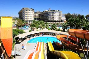 a resort with a pool and slides and buildings at Mukarnas Spa & Resort Hotel in Okurcalar