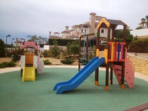 a playground with a slide and a slideintend at Casa Spa in Polop