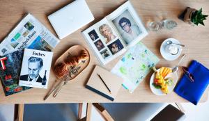 a table topped with photos and a plate of food at Hotel Arima & Spa - Small Luxury Hotels in Donostia-San Sebastián