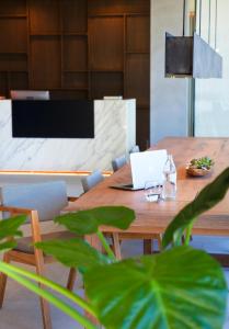 a wooden table with a laptop on top of it at Hotel Arima & Spa - Small Luxury Hotels in Donostia-San Sebastián