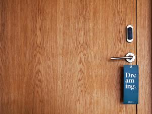 a wooden door with a sign on it at Hotel Arima & Spa - Small Luxury Hotels in Donostia-San Sebastián
