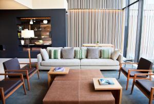 a living room with a couch and tables and chairs at Hotel Arima & Spa - Small Luxury Hotels in Donostia-San Sebastián