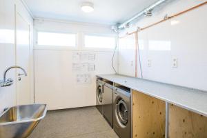 a kitchen with a sink and a washing machine at Horten Apartment in Horten