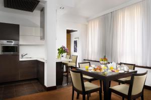 a dining room and kitchen with a table and chairs at Milano Castello Luxury Apartment in Milan