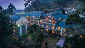an aerial view of a building with lights on at Devonshire Greens - The Leisure Hotel and Spa in Munnar