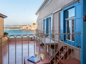 
a view from a balcony of a house with a view of the ocean at Hotel Amphora in Chania Town

