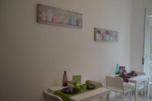 a dining room with two tables and white chairs at B&B BuonaLuna in Salerno