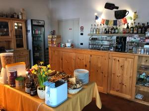 a kitchen with a table with flowers and a counter at Trentino in malga: Malga Zanga in Arco