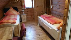 a bedroom with two beds in a wooden cabin at Haus Rheinsteig bei Koblenz in Lahnstein