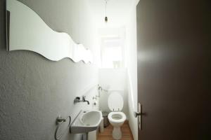 a bathroom with a white toilet and a sink at Apartment Merklingen in Merklingen