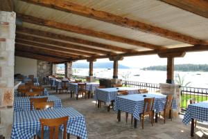 a restaurant with blue and white tables and chairs at Guesthouse Promenade in Medulin