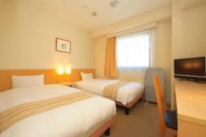 Postel nebo postele na pokoji v ubytování Chisun Hotel Hiroshima