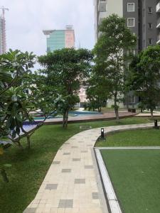 a walkway in a park with trees and buildings at Onthree20 Residencies 2 Room 3 Bed Apartment in Colombo
